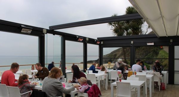 restaurant with outdoor seating under a pergola with a retractable roof