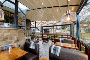 retractable permanent awning with outdoor seating outside restaurant