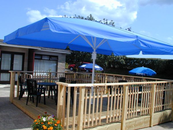 blue garden umbrella covering decking